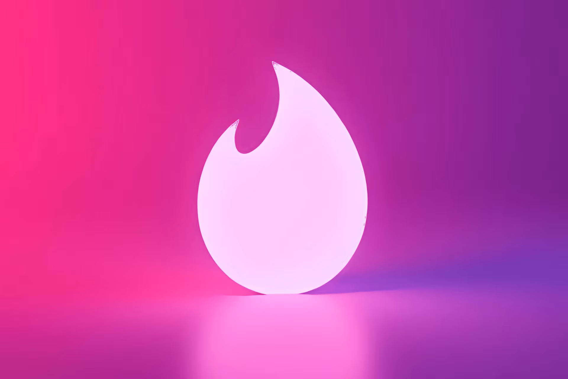 Creator building a Tinder to OnlyFans funnel on a phone next to a laptop